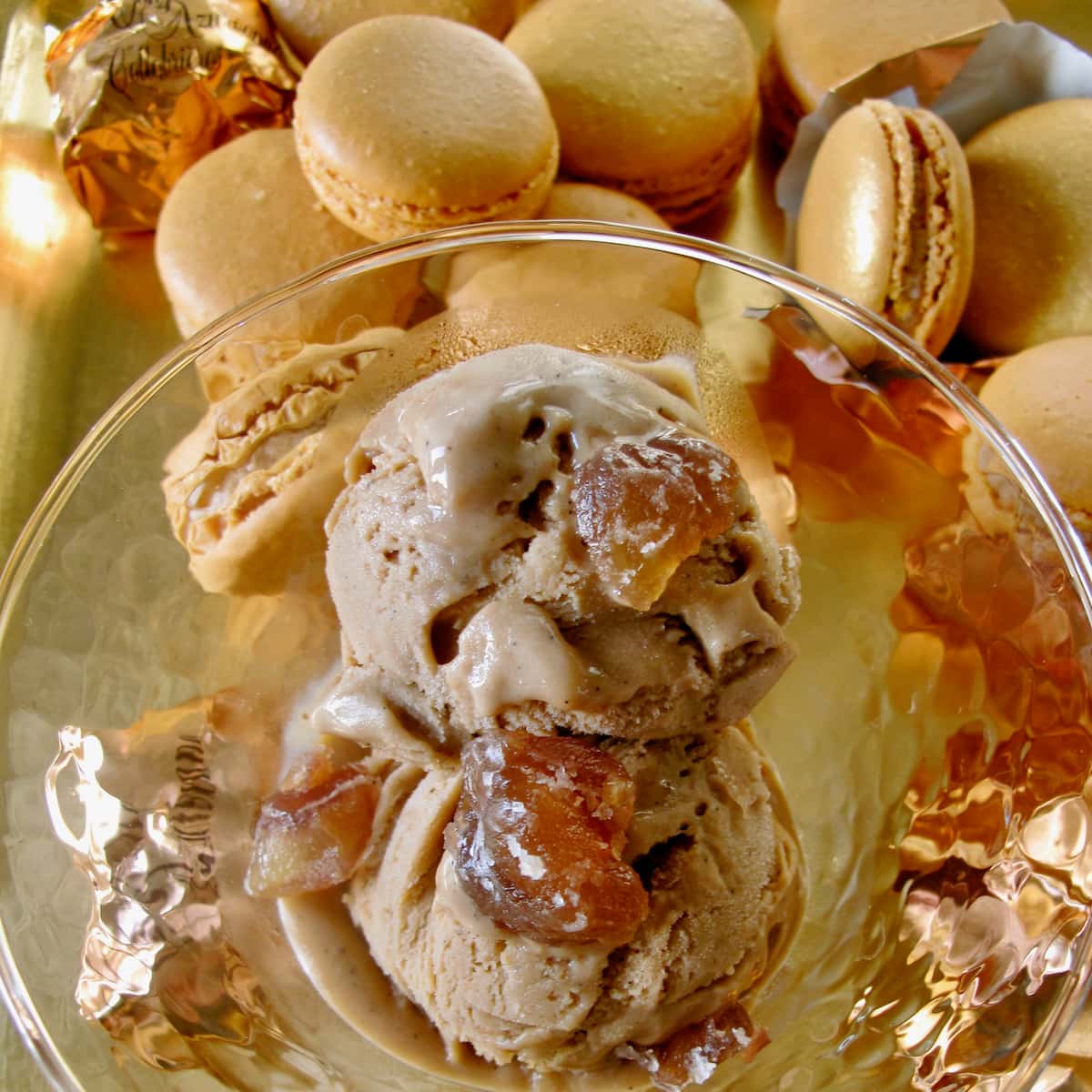 scoops of light chestnut coloured ice cream topped with candied chestnuts