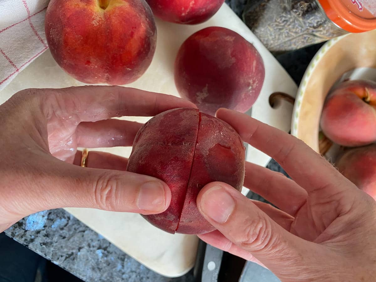 twisting around 2 cut halves of a peach to separate them easily