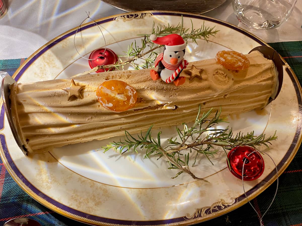 ice cream log cake decorated with candied clementines and rosemary