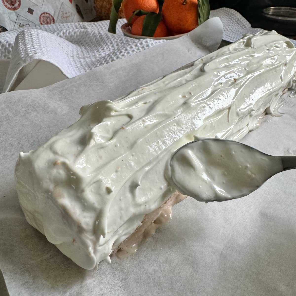 spooning over French meringue on top of an ice cream yule log