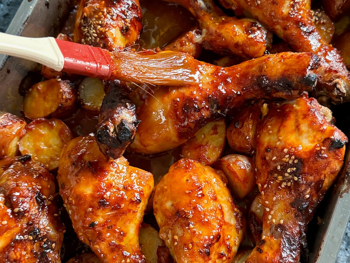baking chicken drumsticks in the oven, turning them over during cooking and brushing with more sauce to glaze
